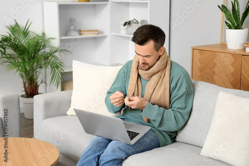 Ill young man taking pills ...
