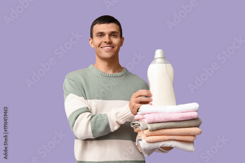 Smiling young man holding f...