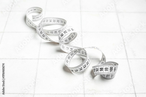 New measuring tape on white...