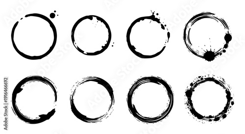 Circular Ink Stains: An eye-level shot captures a collection of unique, black ink stains in the shape of circles, each showcasing its own character and form, with variations in size and detail. 