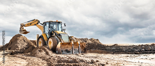 Photos A universal excavator loader moves sand at a construction site
