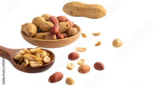 Close-up studio shot featuring two wooden spoons brimming with assorted shelled and unshelled groundnuts, scattered on a black backdrop