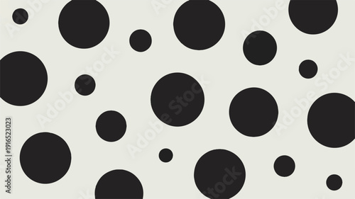 Black circles of various sizes on light gray background pattern