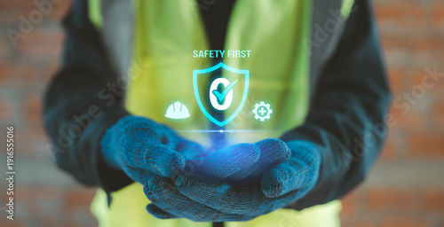 Фотография Construction worker hands holding virtual shield zero accident icon with safety