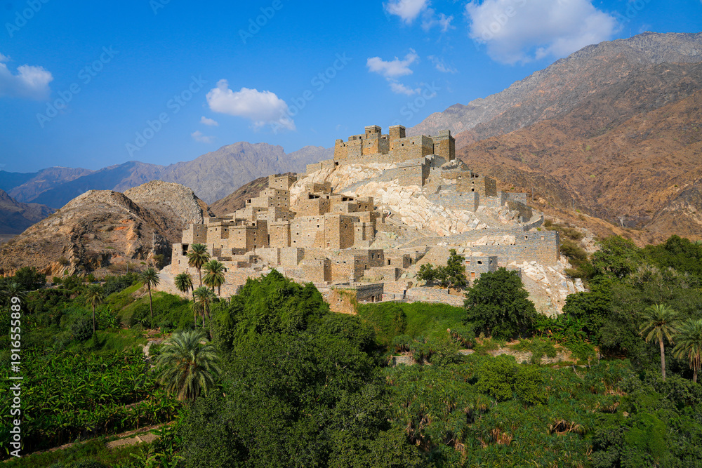 Fototapeta premium Thee Ain Heritage Village, the famous marble village of Al-Baha against a desert mountain backdrop in Saudi Arabia