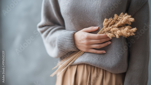 A woman holding a bundle of wheat and her stomach in pain, Gluten allergy, Gluten intolerant concept
