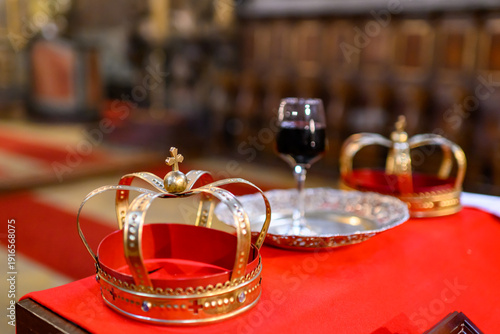 Photography Two crowns, a cup of wine and a cross prepared for baptism
