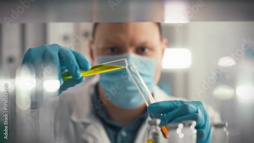 A scientist in a laboratory carefully combines medicinal substances using glass equipment, surrounded by an array of pharmaceuticals and liquid containers