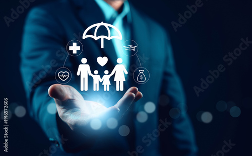 Foto Businessman holding virtual family protection icons with health, education and finance symbols
