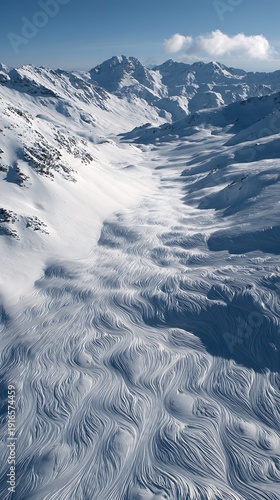 Aerial view of a vast snow-covered mountain range with peaks and valleys