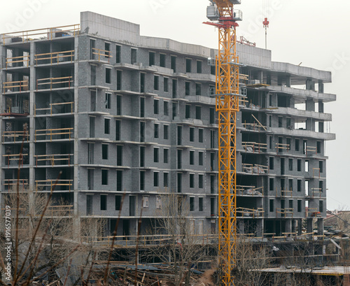 Construction site of modern high-rise concrete building.