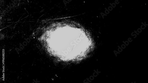 Cinematic film grain texture with central light leak, monochrome grunge vignette background with scratches and dust.