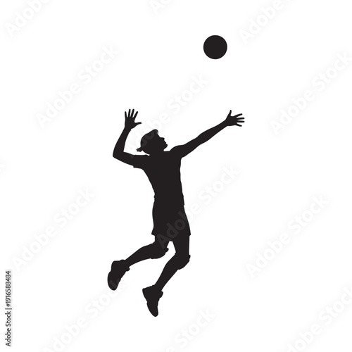 Silhouette of a volleyball player jumping to serve or spike the ball
