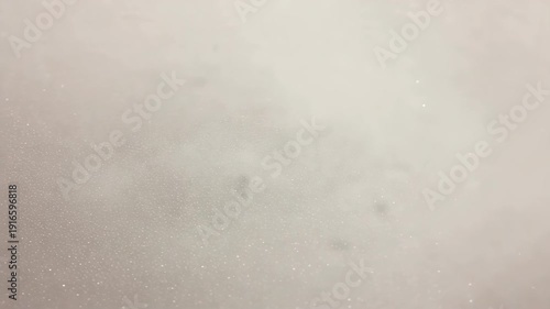 Gentle white foam bubbles surface moving with light glittering glimmering abstract clean motion background