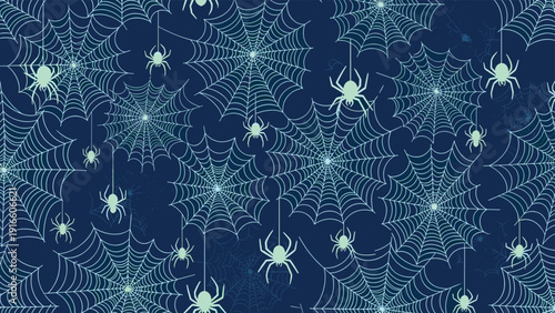 Seamless pattern of glowing spiders and spider webs is displayed on a dark blue background for spooky halloween theme designs.