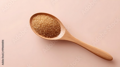 Top down view of a single spoonful of brown sugar on a matte neutral surface evoking a cozy holiday kitchen aesthetic with warm soft light