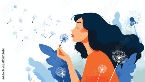 Woman with dark hair blows a dandelion seed head, sending seeds flying with blue foliage