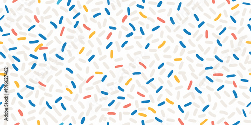 Colorful confetti sprinkles pattern covering a bright white background
