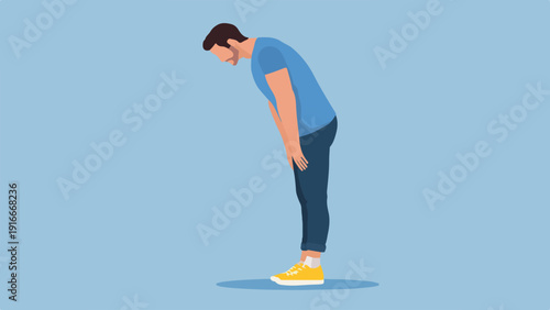 A person in a blue t-shirt and jeans bends over with hands near knees