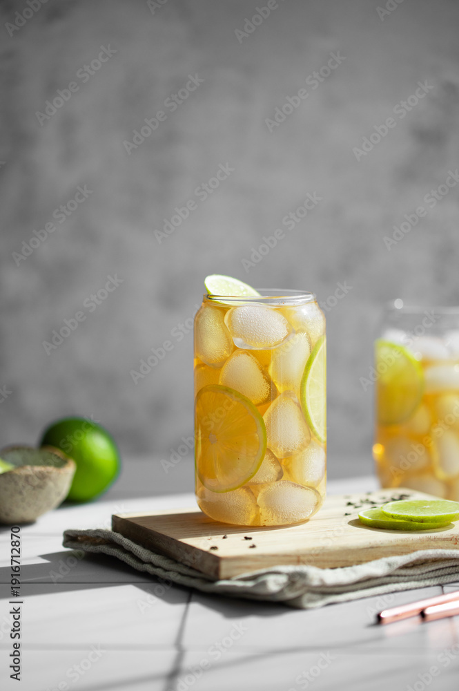 Fototapeta premium Refreshing Iced Tea with Lemon and Lime in Glass Jar, Healthy Summer Drink