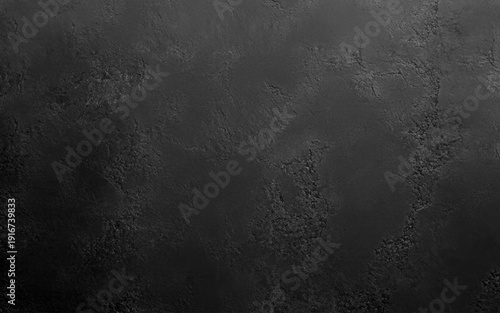 Dark grey black textured concrete wall background. A black background with no visible objects. The background is a solid black color and has a rough texture.