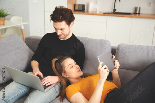 Couple using home internet with mobile devices