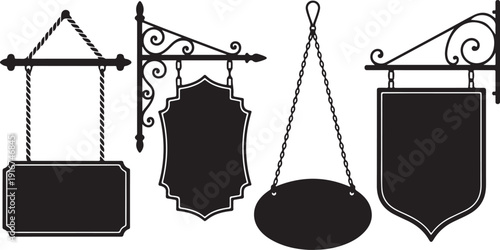 Four black signboards hanging from ornate metal brackets and chains