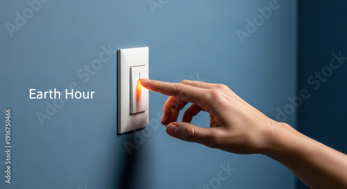 Hand reaching to turn off light switch on blue wall, promoting Earth Hour initiative for energy conservation and environmental awareness