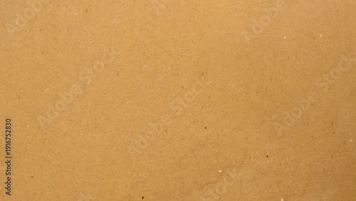 Background of brown kraft paper or cardboard texture. Abstract pattern of beige rough carton, old paper sheet, parchment or papyrus surface.