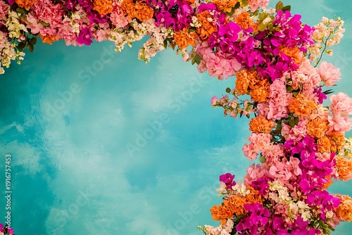 A vibrant circular wedding arch showcasing a blend of pink and orange blooms against a turquoise backdrop, radiating joy,