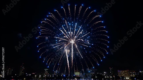 Blue fireworks blooming in the city night sky