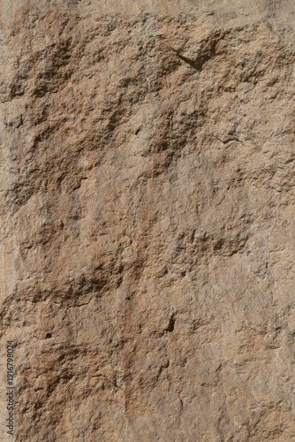 Natural abstract background stone surface featuring a rough textured pattern,...