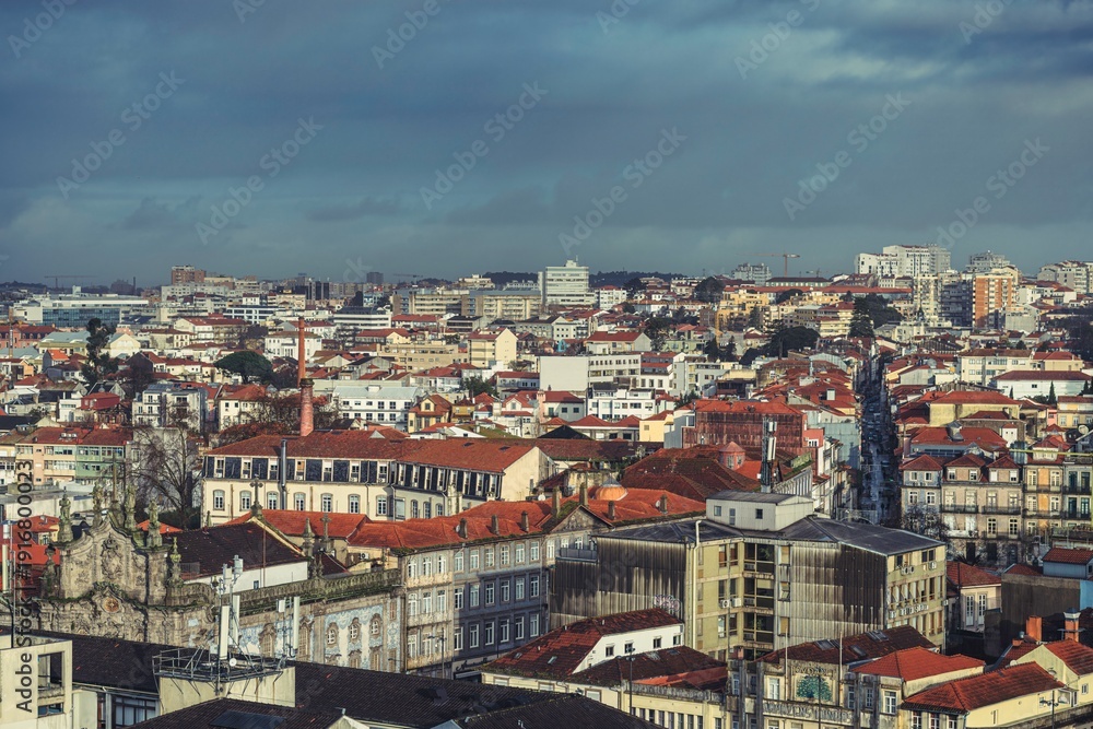 Naklejka premium Feel the charm of Porto with its stunning cityscape featuring traditional rooftops, historic buildings, and the inviting Douro River. A perfect blend of culture and lifestyle awaits