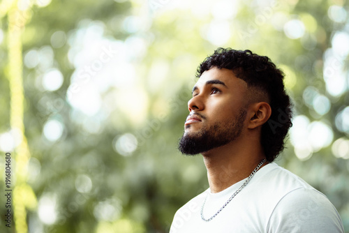Young man looking up with thoughtful expression