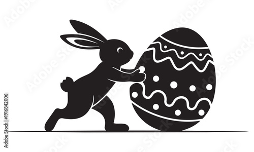 Silhouette of Easter bunny pushing a large decorated egg