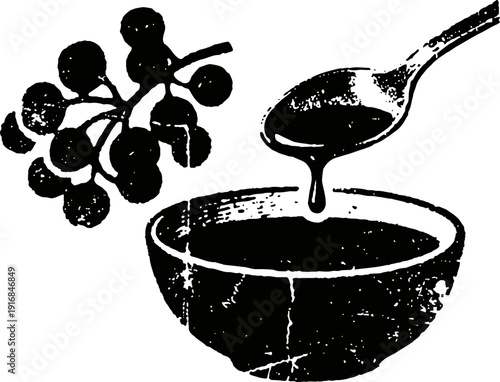 natural elderberry syrup pouring from spoon into bowl with elderberry branch nearby