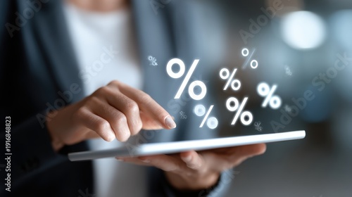 Businesswoman using tablet with glowing percentage symbols floating around her fingers