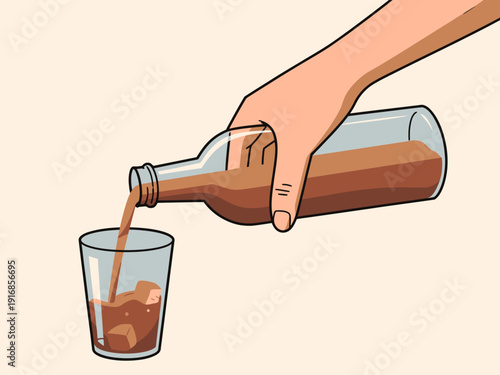 Hand pouring brown liquid from bottle into a glass with ice.