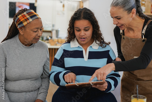Bilde på lerret African mother and daughter ordering food from menu - Family, lifestyle and rest