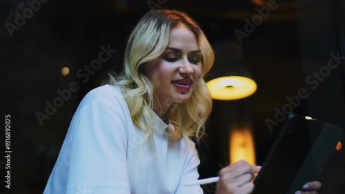 Portrait of smiling Caucasian model with digital tablet, cheerful woman enjoying work in coffee shop, authentic expression of success and happiness, ambitious female entrepreneur using technology