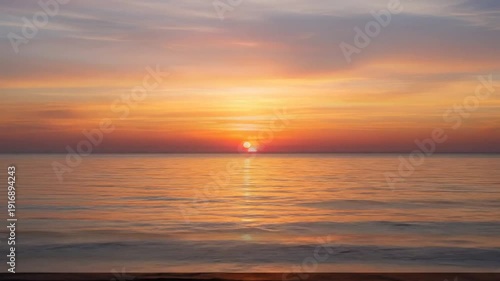 Breathtaking Sunset Over Calm Ocean Waters with Vibrant Sky and Reflections.