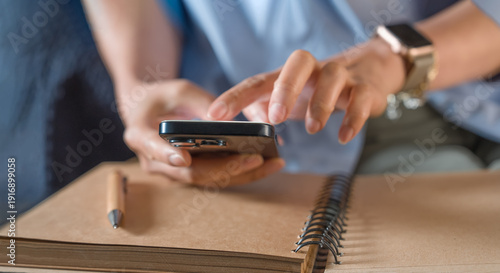 Bilde på lerret Business professional using smartphone to review financial news and research for