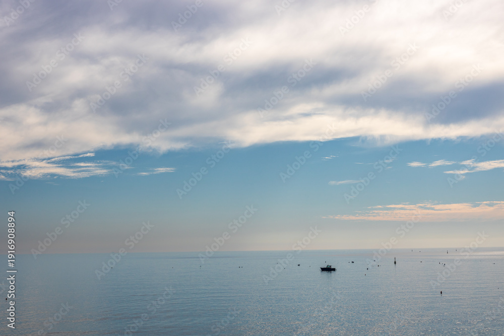 Fototapeta premium Beautiful seascape of the Amalfi Coast in Italy during a colorful sunset at dusk