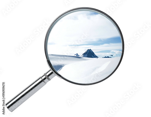 Magnifying glass focuses on a snow-covered mountain range and sky