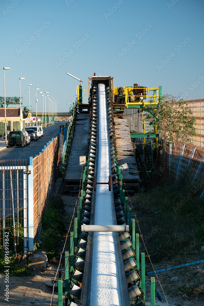 Fototapeta premium Industrial Conveyor Transporting White Granular Material