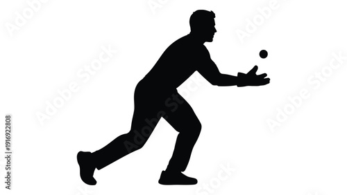 Silhouette of a man attempting to catch a small round object likely a ball