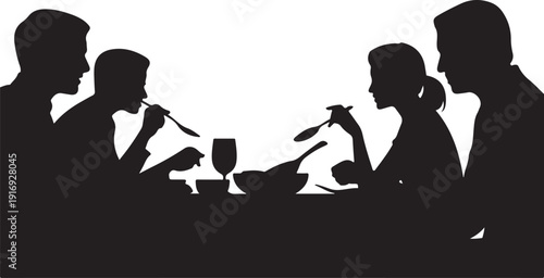 Four people dining together at a table with cutlery and glasses