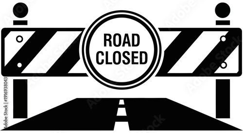Road closure sign with barricade and road closed sign indicating restricted access to the road ahead