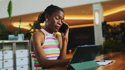 Young African American designer drawing on tablet with stylus in coworking space, creative freelancer working on digital project, female artist sketching on touch screen, startup culture