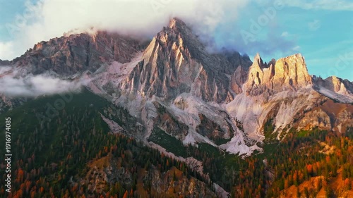 Aerial hyperlapse of high mountain peak with clouds in Dolomites, Italy